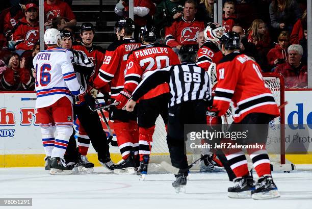 Sean Avery of the New York Rangers is separated from the New Jersey Devils after a Rangers goal at the Prudential Center on March 25, 2010 in Newark,...