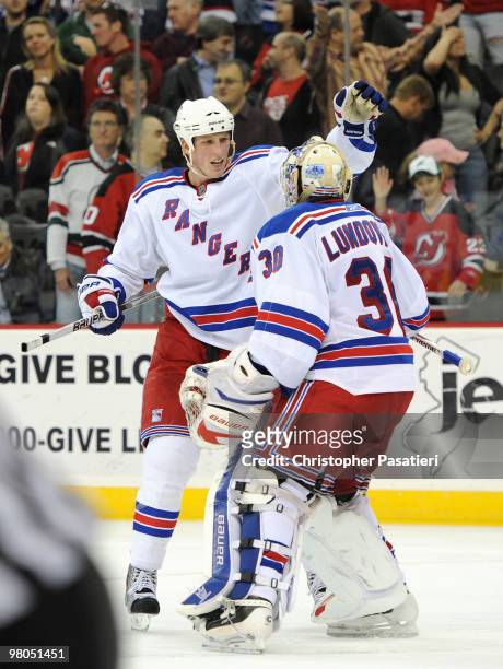 Henrik Lundqvist of the New York Rangers is congratulated by Marc Staal of the New York Rangers after defeating the New Jersey Devils 4-3 in an...