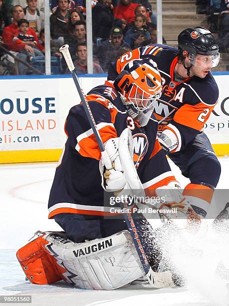 Goalie Martin Biron of the New York Islanders makes a save late in the third period of an NHL game against the Calgary Flames at the Nassau Coliseum...