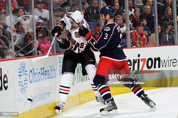 Marc Methot of the Columbus Blue Jackets finishes a check on Tomas Kopecky of the Chicago Blackhawks during the third period on March 25, 2010 at...