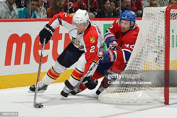 Keith Ballard of the Florida Panthers battles for the puck with Dominic Moore of the Montreal Canadiens during the NHL game on March 25, 2010 at the...