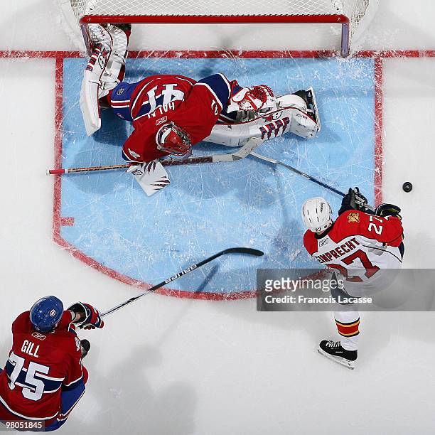 Jaroslav Halak of the Montreal Canadiens blocks the shot of Steve Reinprecht of the Florida Panthers during the NHL game on March 25, 2010 at the...