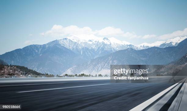 plateau road to snow mountains,tibet - snowy mountain road stock pictures, royalty-free photos & images