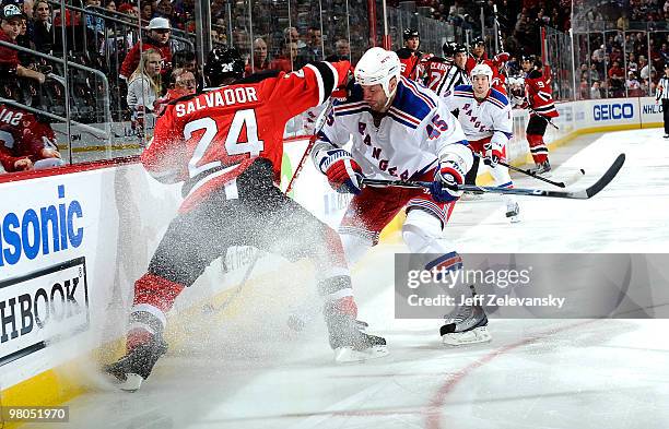 Bryce Salvador of the New Jersey Devils skates with Jody Shelley of the New York Rangers at the Prudential Center on March 25, 2010 in Newark, New...