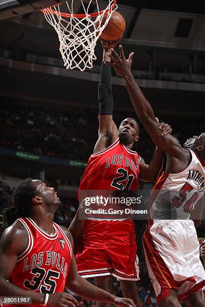 Hakim Warrick of the Chicago Bulls attempts a dunk against Joel Anthony of the Miami Heat on March 25, 2010 at the United Center in Chicago,...