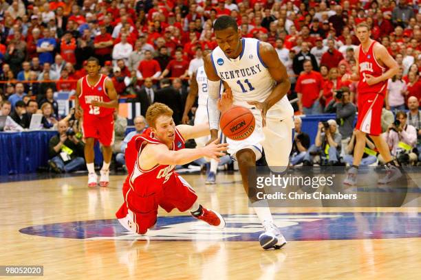 John Wall of the Kentucky Wildcats fights for a loose ball against Chris Wroblewski of the Cornell Big Red during the east regional semifinal of the...