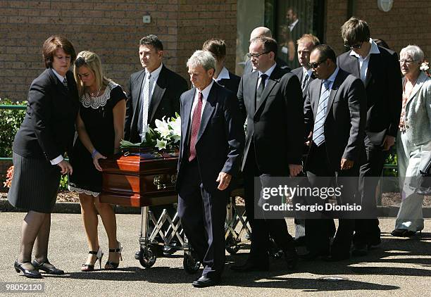 Family members including father Phil Bird and sister Arielle carry the casket of Saxon Bird, the NSW under 19 Ironman champion who died whilst...