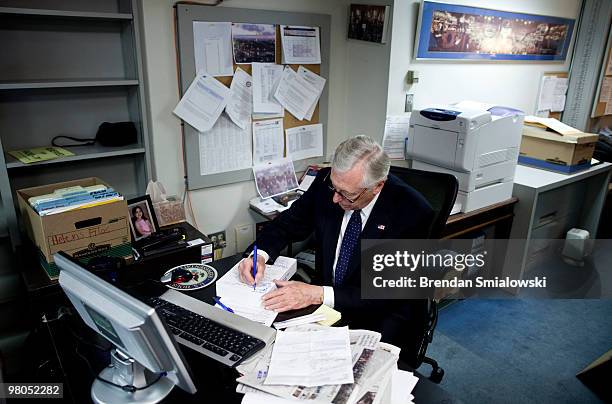 House Majority Leader Steny Hoyer signs a copy of a healthcare reform bill after a vote on Capitol Hill March 25, 2010 in Washington, DC. The House...