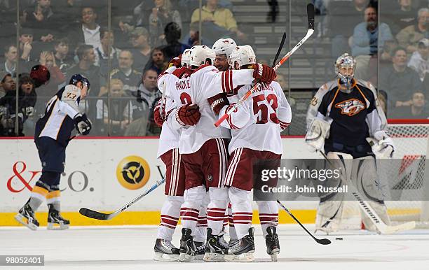 Keith Yandle and Derek Morris of the Phoenix Coyotes celebrate a goal with teammates against goalie Pekka Rinne of the Nashville Predators on March...