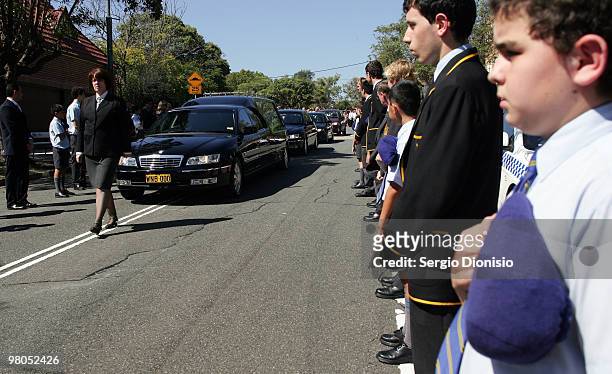 Students from St Patrick's College line the streets during a funeral precession for Saxon Bird, the NSW under 19 Ironman champion who died whilst...