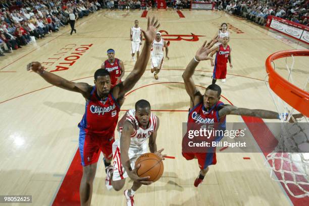 Aaron Brooks of the Houston Rockets shoots the ball over Craig Smith and Rasual Butler of the Los Angeles Clippers on March 25, 2010 at the Toyota...