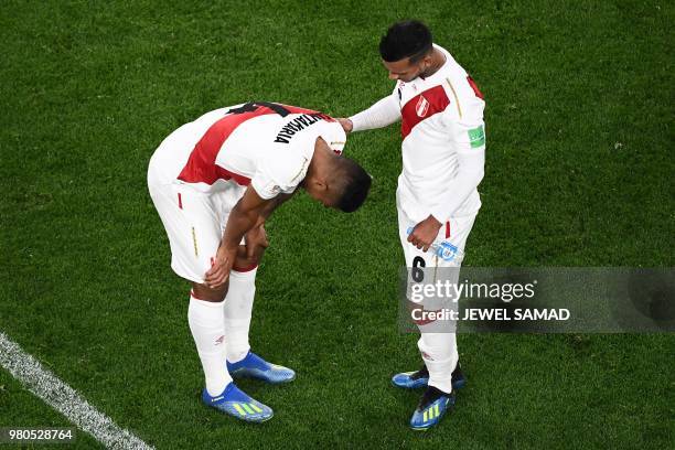 Peru's defender Anderson Santamaria and defender Miguel Trauco react after defeat during the Russia 2018 World Cup Group C football match between...