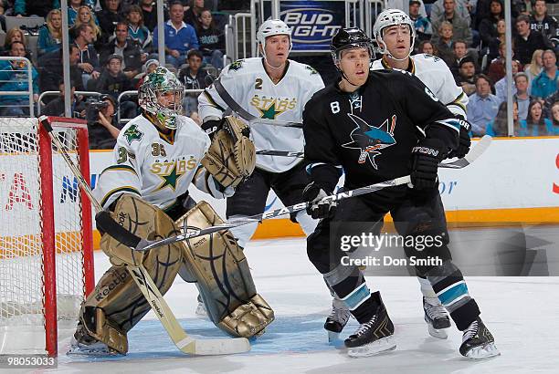 Joe Pavelski of the San Jose Sharks waits for the puck in front of Marty Turco and Nicklas Grossman of the Dallas Stars during an NHL game on March...