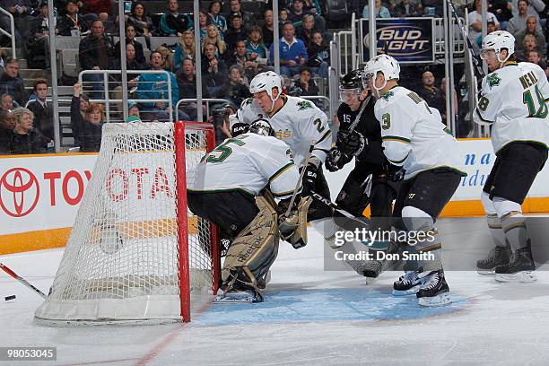 Dany Heatley of the San Jose Sharks tries to follow the puck behind the net past Marty Turco, Nicklas Grossman, Stephane Robidas and Jamie Benn of...