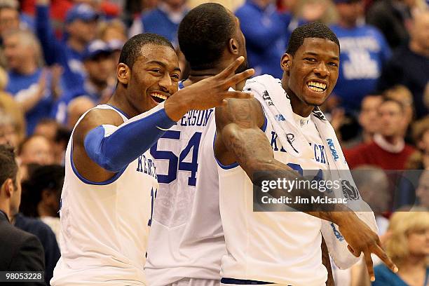 John Wall and DeAndre Liggins of the Kentucky Wildcats celebrate Kentucky's 62-45 win against the Cornell Big Red during the east regional semifinal...