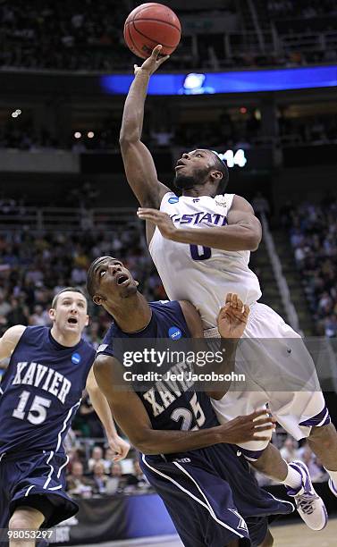 Jacob Pullen of the Kansas State Wildcats shoots against Dante Jackson of the Xavier Musketeers during the third round of the 2010 NCAA men�s...