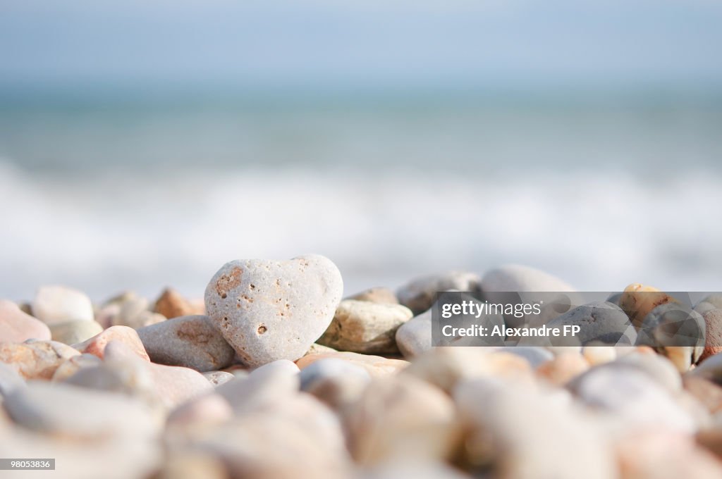 Heart shaped pebble on the beach