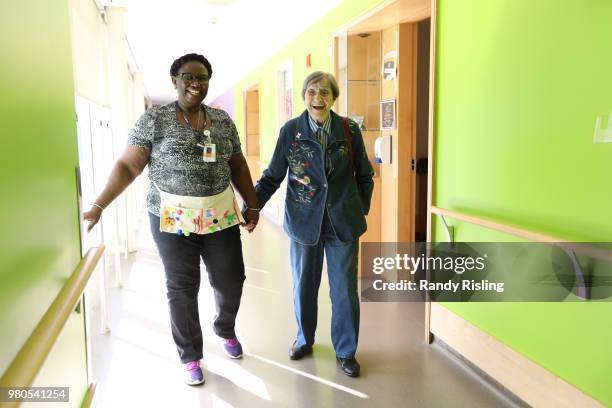 September 28: Malton Village resident Inga Cherry walks through the hallway with Geva Lindsay, a personal support worker.