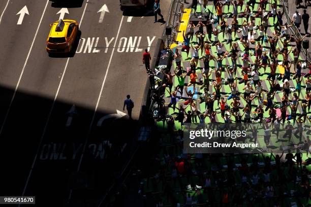 Yoga enthusiasts participate in a mass yoga class in Manhattan's Times Square to celebrate the summer solstice and mark World Yoga Day, June 21, 2018...