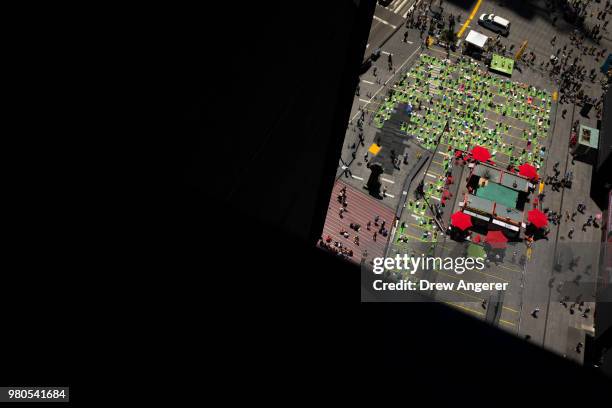 Yoga enthusiasts participate in a mass yoga class in Manhattan's Times Square to celebrate the summer solstice and mark World Yoga Day, June 21, 2018...