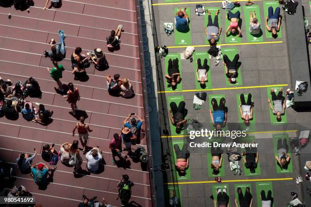 Yoga enthusiasts participate in a mass yoga class in Manhattan's Times Square to celebrate the summer solstice and mark World Yoga Day, June 21, 2018...