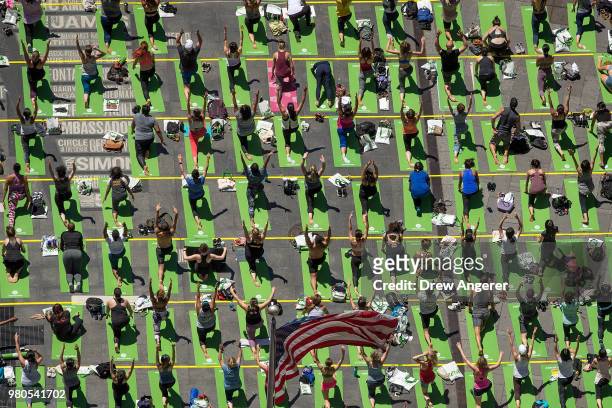 Yoga enthusiasts participate in a mass yoga class in Manhattan's Times Square to celebrate the summer solstice and mark World Yoga Day, June 21, 2018...