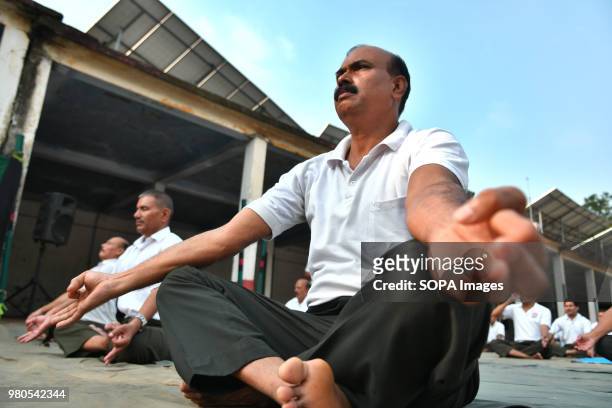 Members of the military force spreading their hands out relaxing during the session. Soldiers of paramilitary force doing yoga on the occasion of...