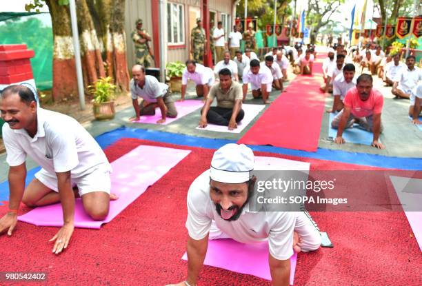 Members of the security force stretching on their knees during the yoga session. The soldiers of Border Security Force of India doing Yoga on the...