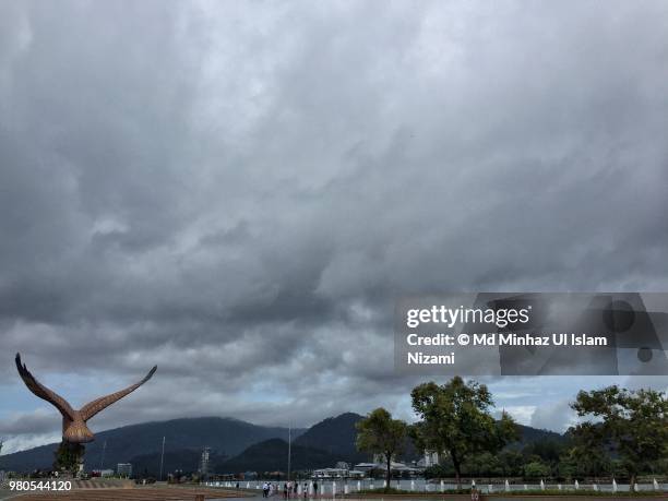 famous eagle square at kuah beach of langkawi with cloudy weather. - langkawi eagle square stock pictures, royalty-free photos & images