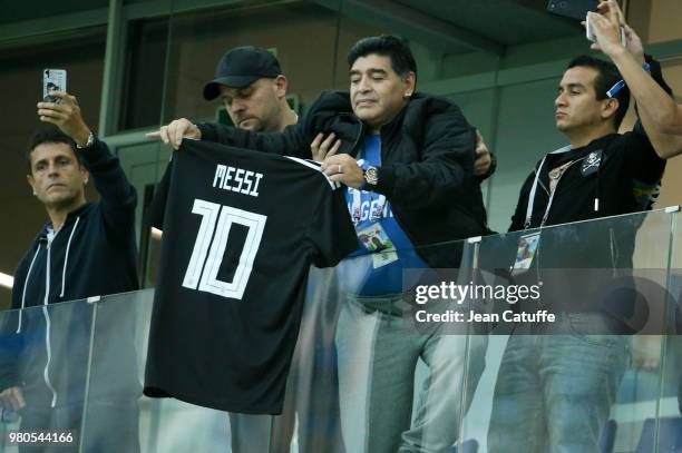 Diego Maradona brandishes the jersey of Lionel Messi of Argentina during the 2018 FIFA World Cup Russia group D match between Argentina and Croatia...