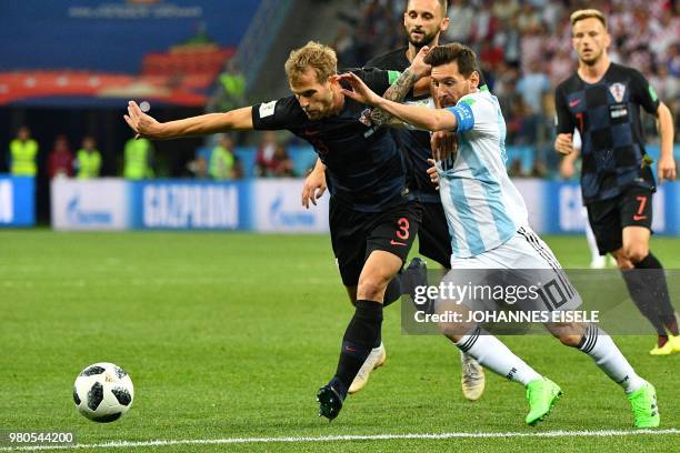Croatia's defender Ivan Strinic vies with Argentina's forward Lionel Messi during the Russia 2018 World Cup Group D football match between Argentina...