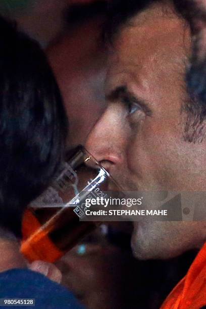 French President Emmanuel Macron has a glass of wine at a bar as he watches France play Peru in the Russia World Cup 2018 Soccer match in...