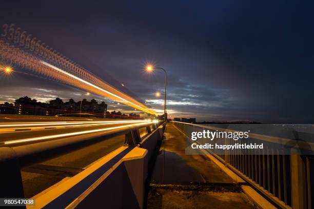 vehicle light trails on benjamin sheares bridge, singapore - balustrade stock photos et images de collection