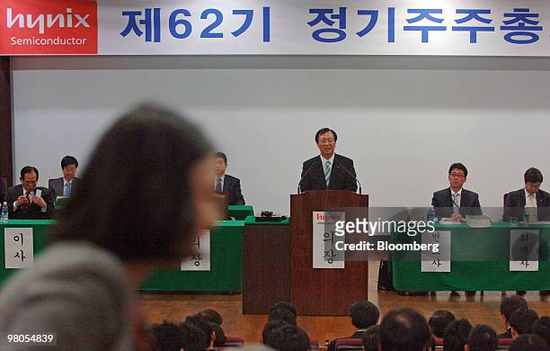 Kim Jong Kap, chief executive officer of Hynix Semiconductor Inc., center, speaks during the annual general shareholders meeting at the company's...