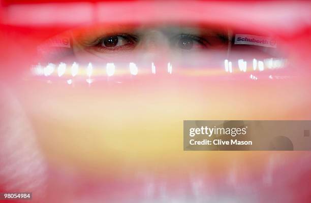 Fernando Alonso of Spain and Ferrari is seen in his team garage as he prepares to drive during practice for the Australian Formula One Grand Prix at...