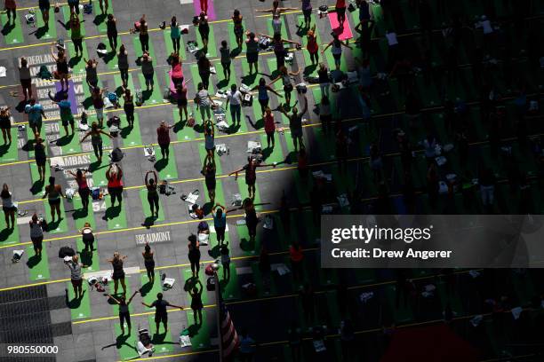 Yoga enthusiasts participate in a mass yoga class in Manhattan's Times Square to celebrate the summer solstice and mark World Yoga Day, June 21, 2018...