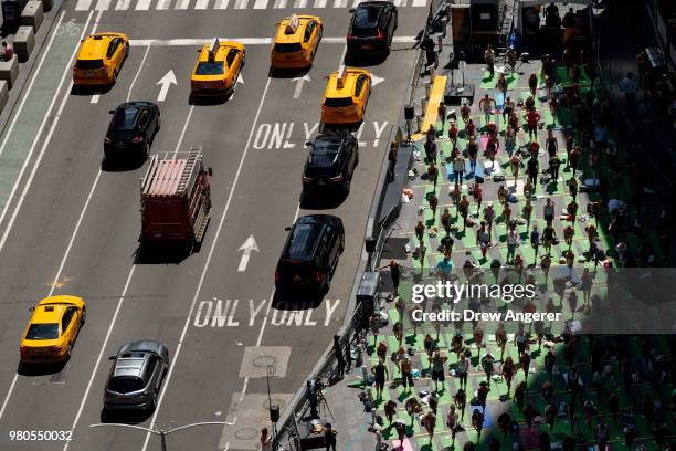 Yoga enthusiasts participate in a mass yoga class in Manhattan's Times Square to celebrate the summer solstice and mark World Yoga Day, June 21, 2018...