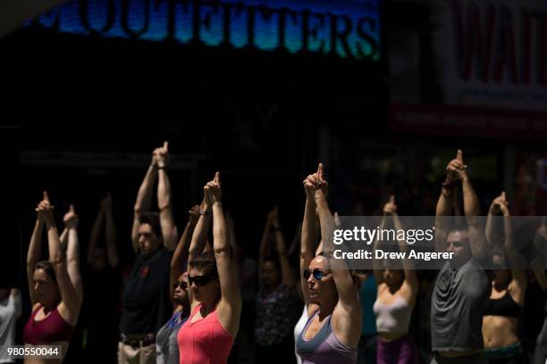 Yoga enthusiasts participate in a mass yoga class in Manhattan's Times Square to celebrate the summer solstice and mark World Yoga Day, June 21, 2018...