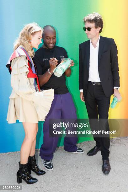 Stylist Virgil Abloh standing between Natalia Vodianova and General manager of Berluti Antoine Arnault pose after the Louis Vuitton Menswear...