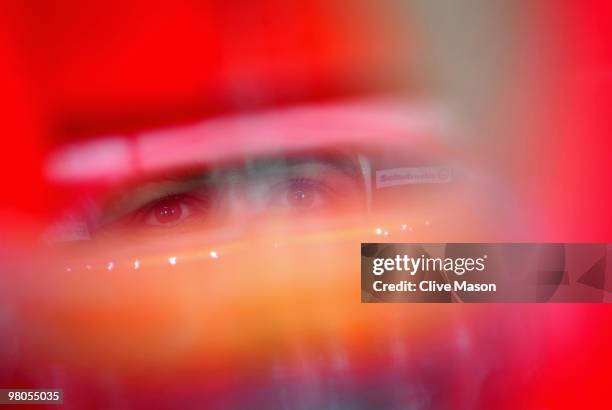 Fernando Alonso of Spain and Ferrari is seen in his team garage as he prepares to drive during practice for the Australian Formula One Grand Prix at...