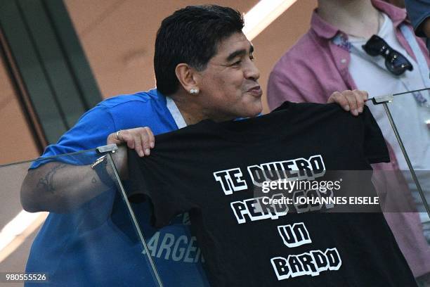 Argentina's football legend Diego Maradona poses with a tshirt reading "I love you but i'm a mess" in the grandstand before the Russia 2018 World Cup...