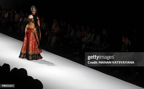 Indian Bollywood actress Koena Mitra presents a creation by Indian designer Joy Mitra during the Wills India Fashion Week Autumn-Winter 2010 in New...