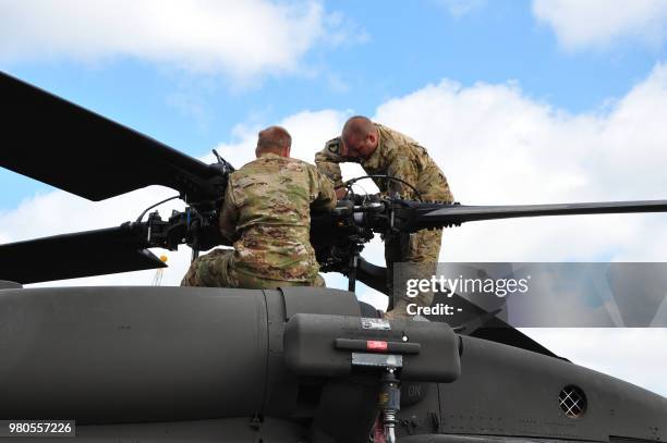 Army personnel assembles a rotor blade on a Black Hawk transport helicopter in the Rotterdam harbour on June 21, 2018. - The helicopters were...