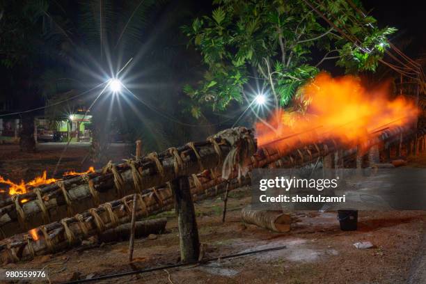 traditional cannon made from coconut palm tree light up during the celebration of eid-mubarak. - eid mubarak stockfoto's en -beelden