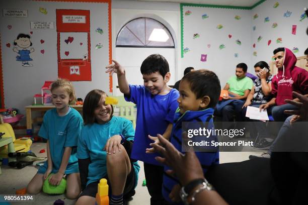Recently arrived migrant children play with family and volunteer children at the Catholic Charities Humanitarian Respite Center on June 21, 2018 in...