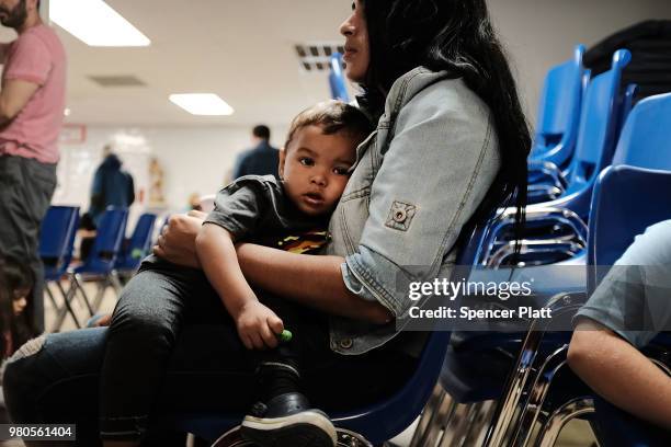 Woman who idendtified herself as Jennifer sits with her son Jaydan at the Catholic Charities Humanitarian Respite Center after recently crossing the...