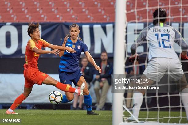 United States forward Alex Morgan battles with China PR defender Wu Haiyan for the ball during an international friendly soccer match between the USA...