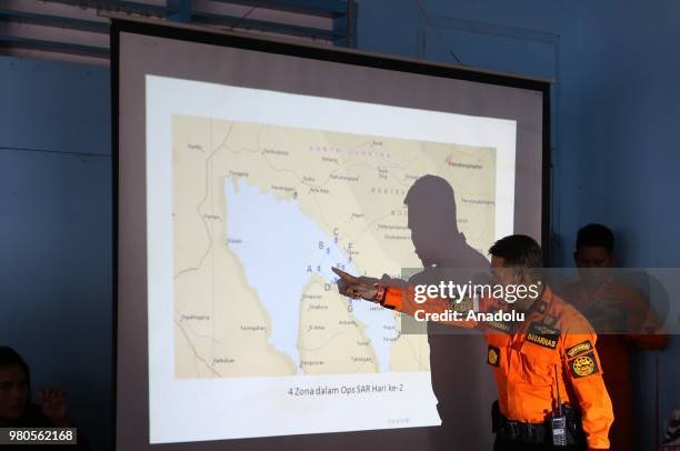 Head of North Sumatra National SAR Agency, Budiawan shows the sinking location of KM Sinar Bangun on a map in Lake Toba, Simalungun, North Sumatra on...