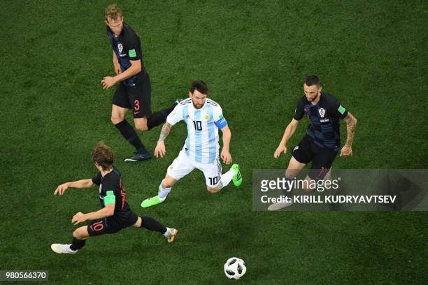 Argentina's forward Lionel Messi fights for the ball with Croatia's midfielder Luka Modric, Croatia's defender Ivan Strinic and Croatia's midfielder...