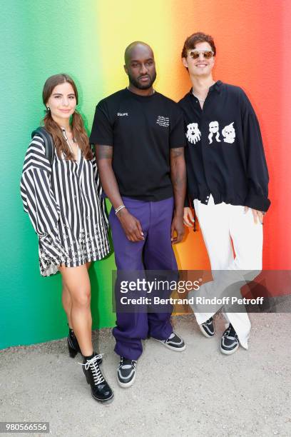 Stylist Virgil Abloh standing between actor Ansel Elgort and guest pose after the Louis Vuitton Menswear Spring/Summer 2019 show as part of Paris...